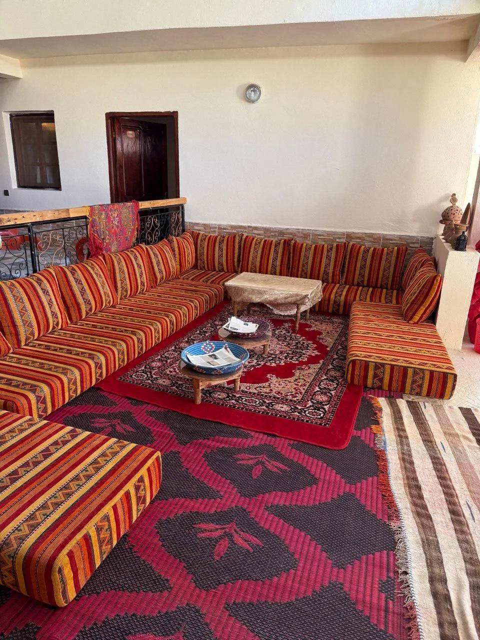 Colourful cushions and rugs in a traditional Berber guesthouse lounge